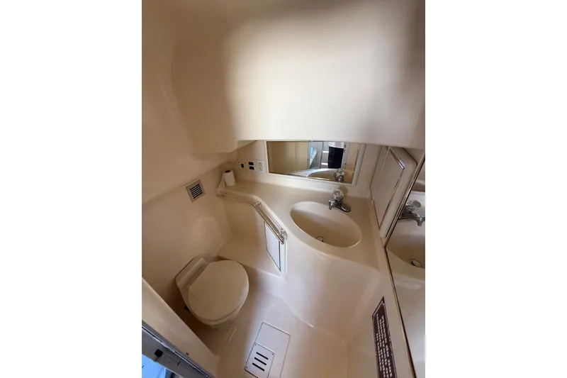 Slide: The Image of Bathroom interior of 1991 Sea Ray 630 Super Sun Sport yacht, featuring sink and toilet. - 51