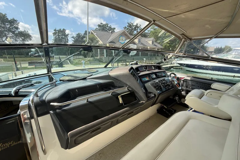 Slide: The Image of Interior view of 1991 Sea Ray 630 Super Sun Sport yacht cockpit with steering and controls. - 22