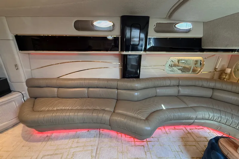 Slide: The Image of Luxurious interior of a 1991 Sea Ray 630 Super Sun Sport yacht with curved leather seating. - 30