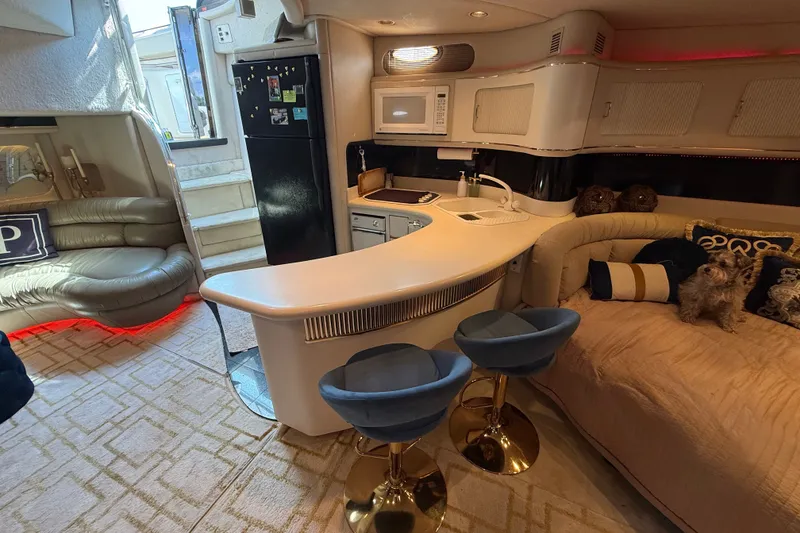 Slide: The Image of Luxurious interior of 1991 Sea Ray 630 Super Sun Sport yacht with modern kitchen and seating area. - 32