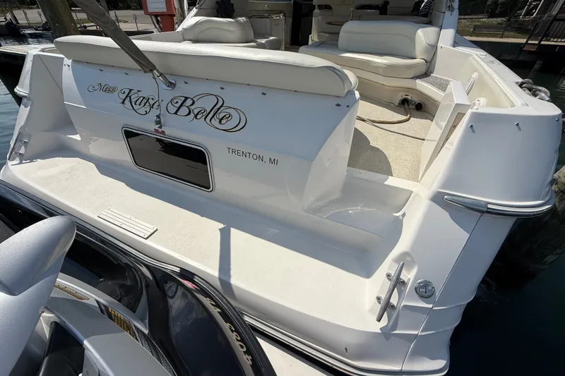 Slide: The Image of 1991 Sea Ray 630 Super Sun Sport yacht docked, featuring spacious seating and elegant design. - 11