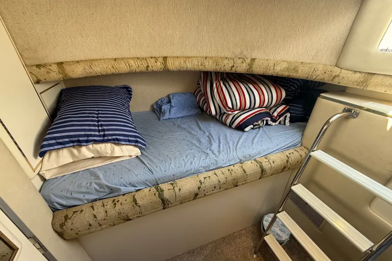 Slide: The Image of Cozy cabin bed with striped pillows in 1991 Sea Ray 630 Super Sun Sport yacht. - 48