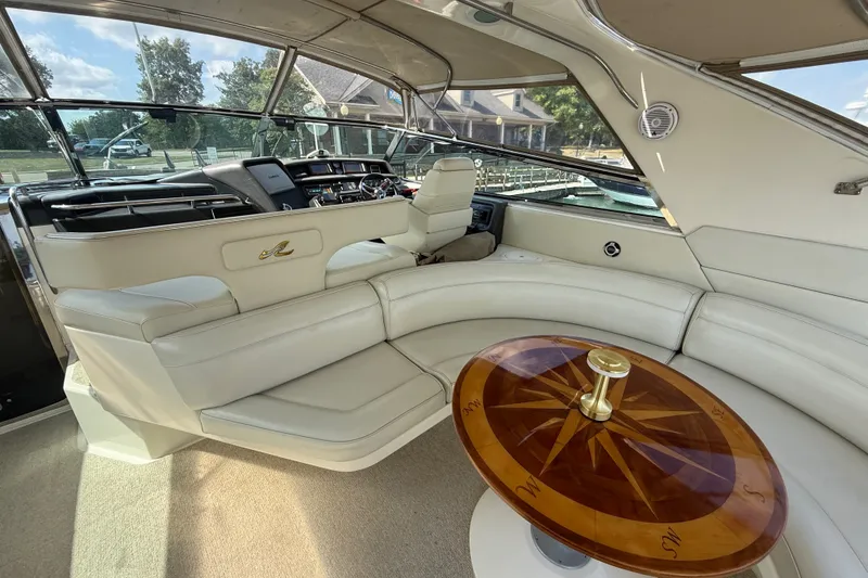 Slide: The Image of Interior of 1991 Sea Ray 630 Super Sun Sport yacht with luxurious seating and wooden table. - 17
