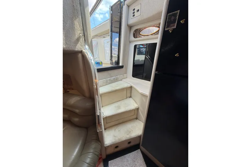 Slide: The Image of Interior view of 1991 Sea Ray 630 Super Sun Sport yacht with stairs and seating. - 31