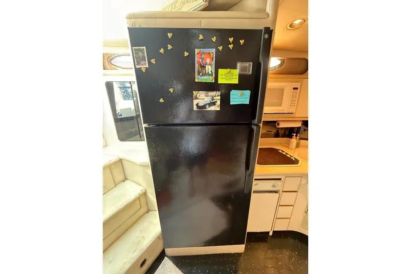 Slide: The Image of Black refrigerator in 1991 Sea Ray 630 Super Sun Sport yacht kitchen. - 36