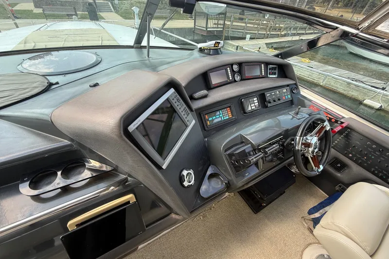 Slide: The Image of Cockpit of 1991 Sea Ray 630 Super Sun Sport yacht with advanced navigation controls. - 23