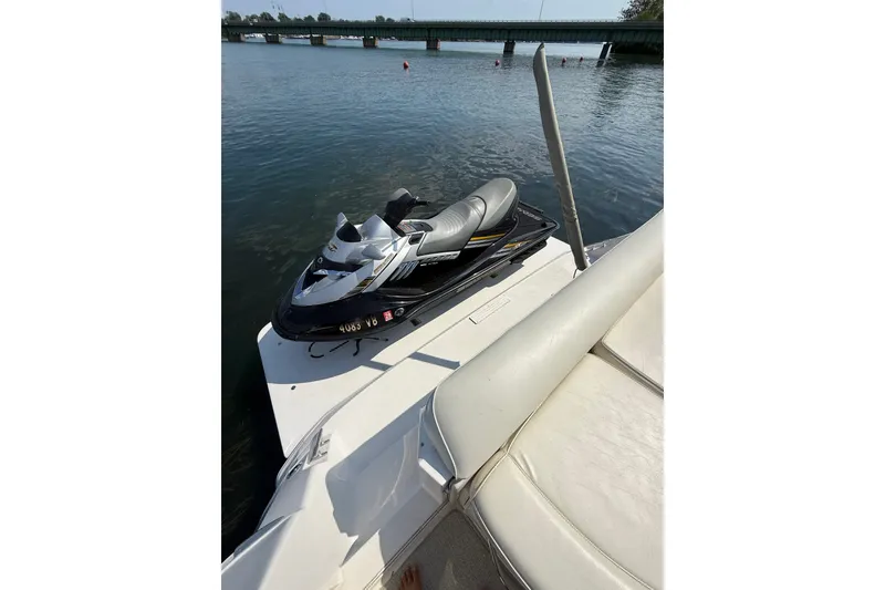 Slide: The Image of Jet ski on a 1991 Sea Ray 630 Super Sun Sport yacht, near a bridge. - 9