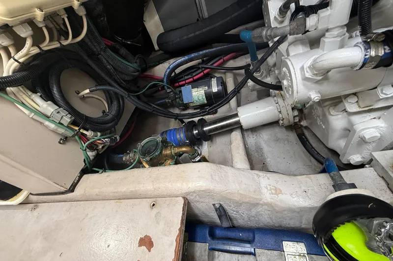 Slide: The Image of Engine compartment of a 2004 Sea Ray 550 Sundancer with visible mechanical components. - 56