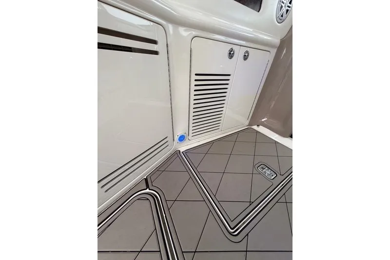 Slide: The Image of 2004 Sea Ray 550 Sundancer interior with sleek cabinetry and patterned flooring. - 79