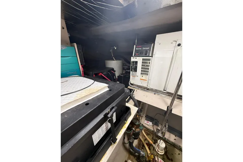 Slide: The Image of Engine room of 2004 Sea Ray 550 Sundancer with marine generator and equipment. - 62