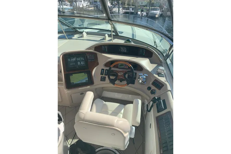 Slide: The Image of Helm of 2004 Sea Ray 550 Sundancer with navigation displays and controls. - 84