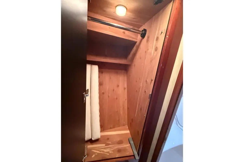 Slide: The Image of Wooden closet interior on a 2004 Sea Ray 550 Sundancer yacht. - 31