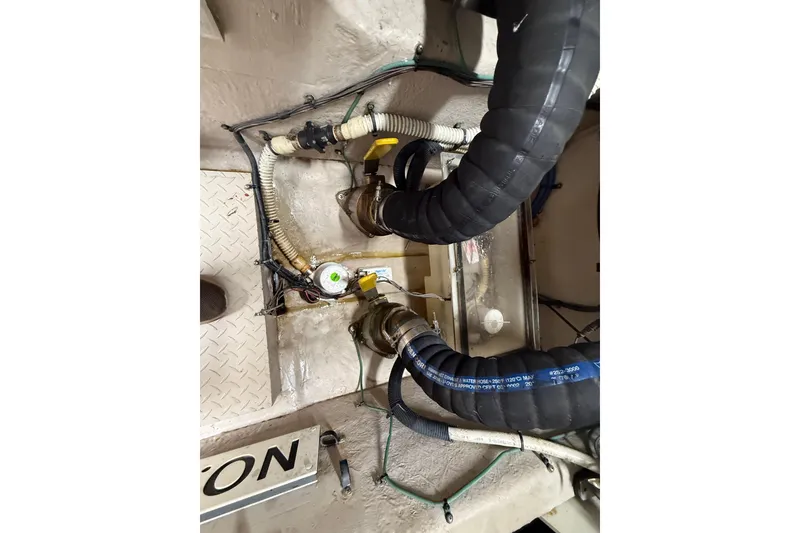 Slide: The Image of Engine compartment of a 2004 Sea Ray 550 Sundancer with visible hoses and wiring. - 52