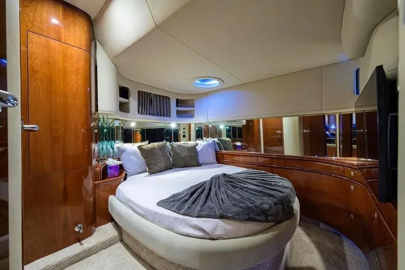 Slide: The Image of Luxurious bedroom interior of 2004 Sea Ray 550 Sundancer yacht with round bed and wood finish. - 22