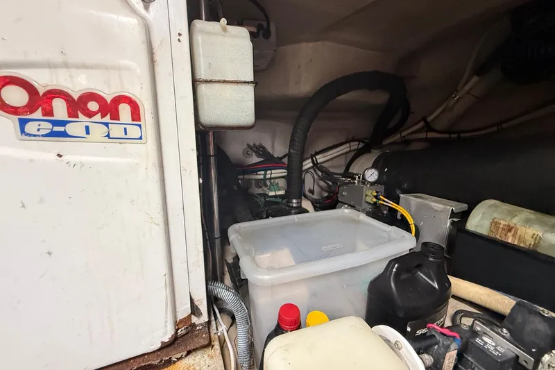 Slide: The Image of Engine compartment of 2004 Sea Ray 550 Sundancer with Onan generator and various components. - 67