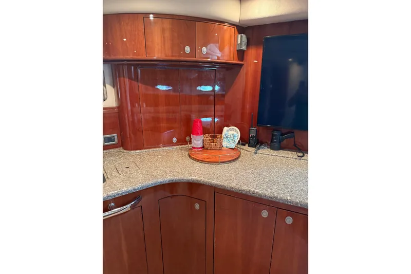 Slide: The Image of Luxurious 2004 Sea Ray 550 Sundancer yacht interior with polished wood cabinetry. - 13