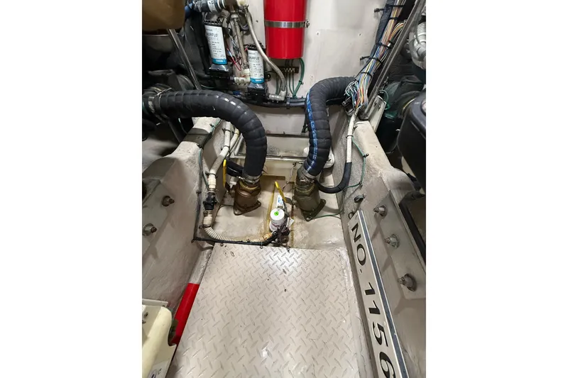 Slide: The Image of Engine room of 2004 Sea Ray 550 Sundancer with hoses and fire extinguisher. - 50