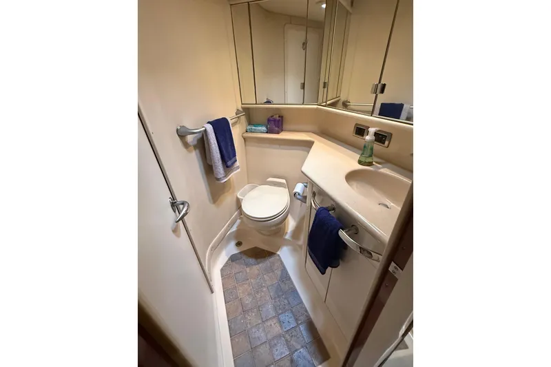 Slide: The Image of Bathroom interior of 2004 Sea Ray 550 Sundancer yacht, featuring sink and toilet. - 77