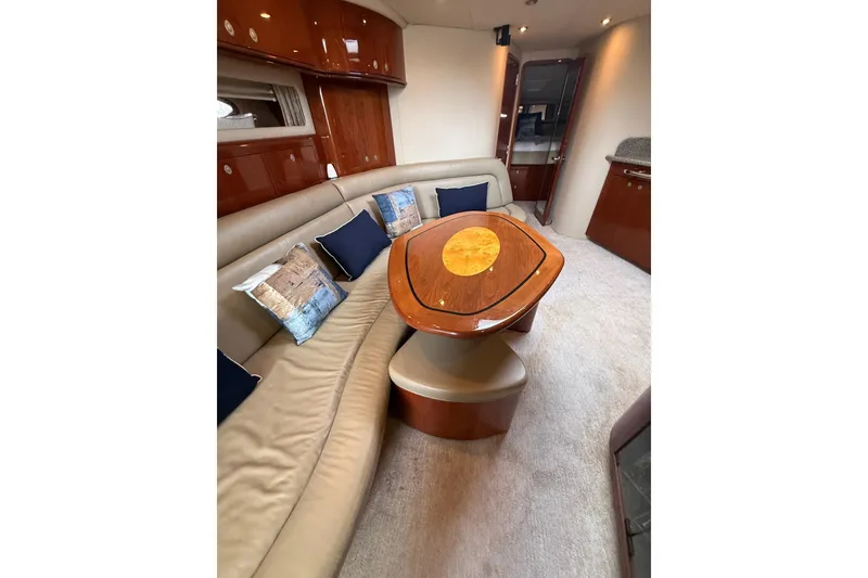 Slide: The Image of Luxurious interior of 2004 Sea Ray 550 Sundancer yacht with elegant seating and wooden table. - 97
