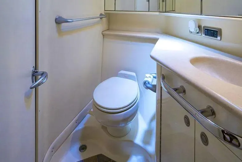Slide: The Image of 2004 Sea Ray 550 Sundancer yacht bathroom with toilet and sink, featuring modern fixtures. - 34