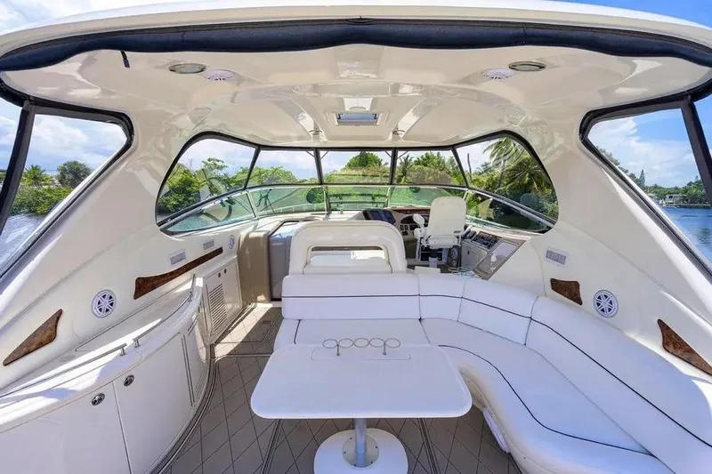 Slide: The Image of Luxurious interior of 2004 Sea Ray 550 Sundancer yacht with white seating and panoramic windows. - 15