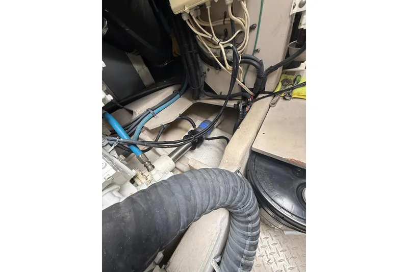 Slide: The Image of Engine room of 2004 Sea Ray 550 Sundancer with visible hoses and wiring. - 55