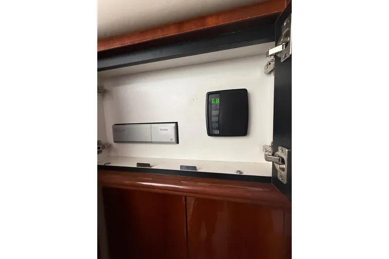 Slide: The Image of 2004 Sea Ray 550 Sundancer interior cabinet with electronic control panel. - 110