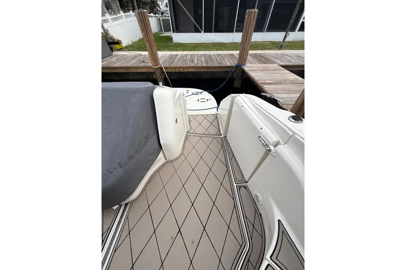 Slide: The Image of 2004 Sea Ray 550 Sundancer yacht docked, featuring sleek deck design and comfortable seating. - 75