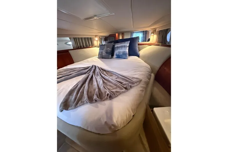 Slide: The Image of Luxurious cabin interior of 2004 Sea Ray 550 Sundancer yacht with cozy bedding. - 23