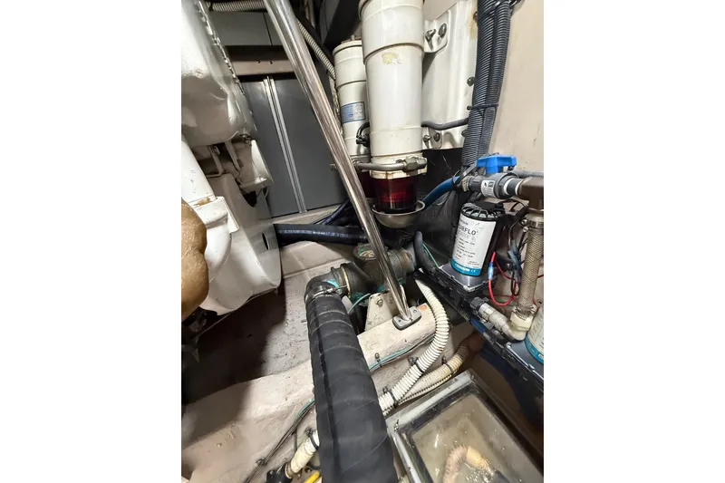 Slide: The Image of Engine room of 2004 Sea Ray 550 Sundancer with visible hoses and filters. - 51