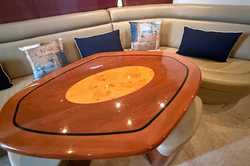 Slide: The Image of Luxurious interior of 2004 Sea Ray 550 Sundancer with elegant wood table and plush seating. - 92