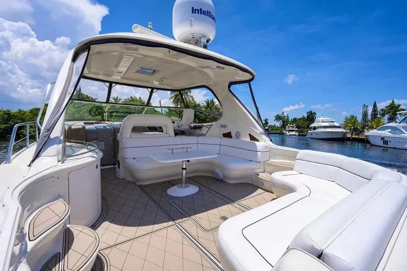 Slide: The Image of Luxurious 2004 Sea Ray 550 Sundancer yacht interior with white seating and scenic waterway view. - 33