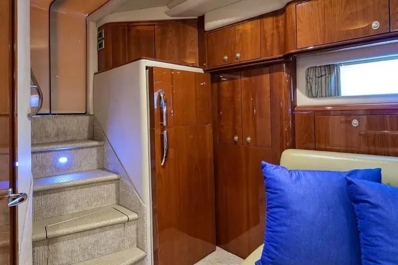 Slide: The Image of Luxurious interior of 2004 Sea Ray 550 Sundancer yacht with wooden cabinetry and blue cushions. - 17