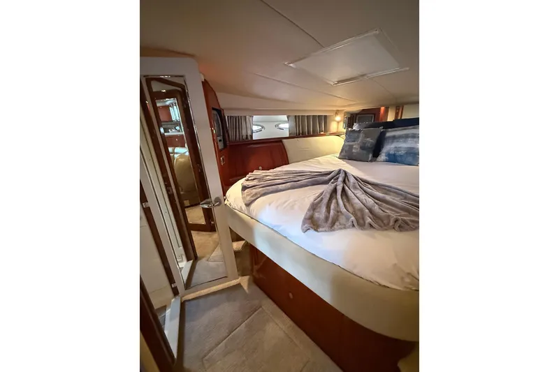 Slide: The Image of Luxurious cabin interior of 2004 Sea Ray 550 Sundancer yacht with cozy bedding. - 87