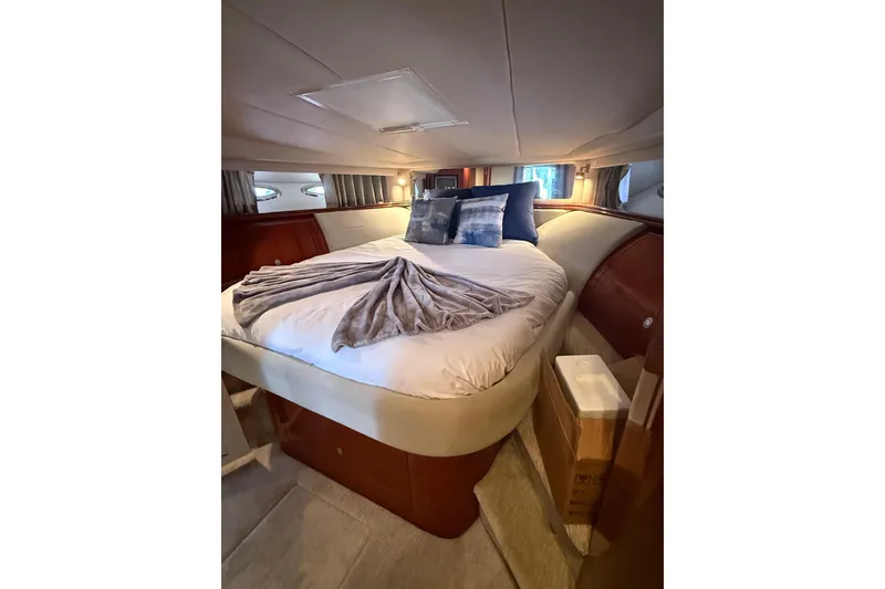Slide: The Image of Luxurious bedroom interior of 2004 Sea Ray 550 Sundancer yacht with cozy bedding. - 86