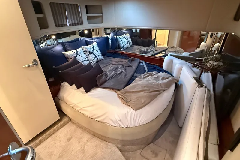 Slide: The Image of Luxurious cabin interior of a 2004 Sea Ray 550 Sundancer yacht with plush bedding. - 29