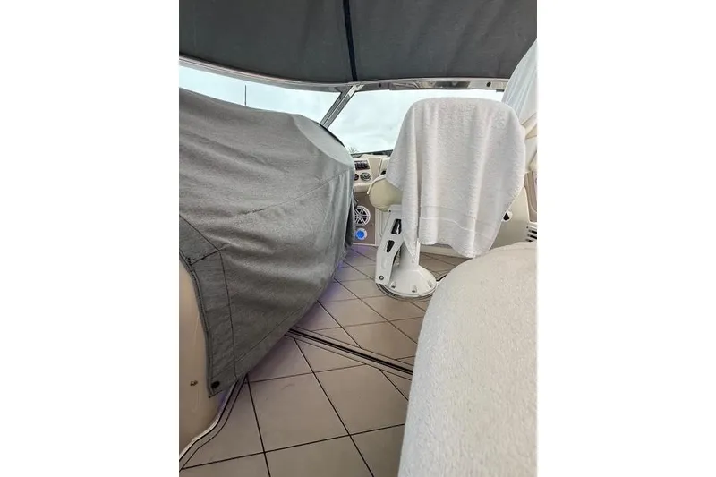 Slide: The Image of Interior of a 2004 Sea Ray 550 Sundancer yacht with covered seating. - 80