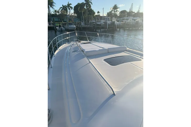Slide: The Image of 2004 Sea Ray 550 Sundancer yacht docked, featuring sleek deck design and waterfront view. - 85