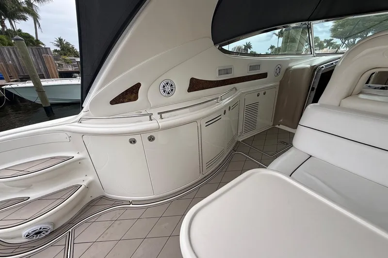 Slide: The Image of 2004 Sea Ray 550 Sundancer yacht interior with sleek white seating and cabinetry. - 74
