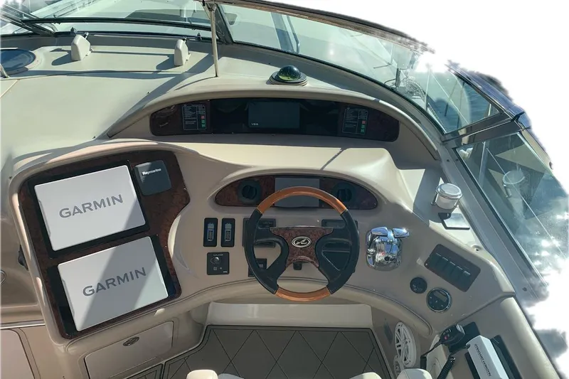 Slide: The Image of 2004 Sea Ray 550 Sundancer helm with Garmin navigation and wood-accented steering wheel. - 7