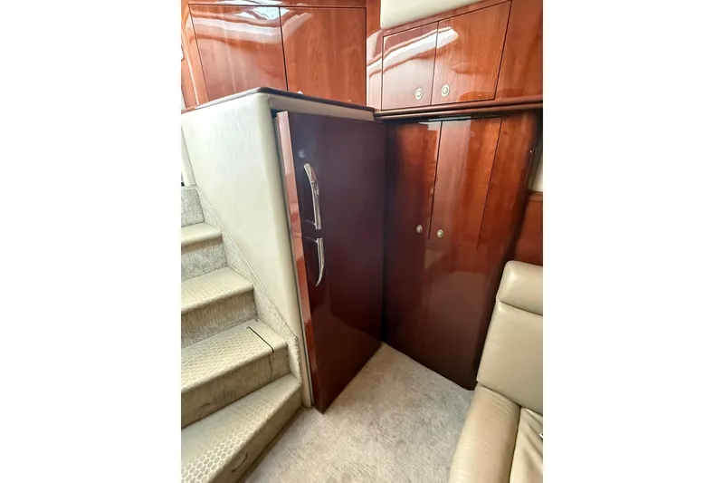 Slide: The Image of Interior of 2004 Sea Ray 550 Sundancer with wooden cabinets and carpeted stairs. - 94