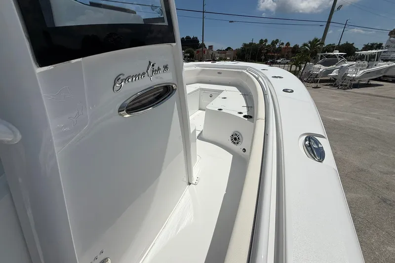 Slide: The Image of 2026 Sea Hunt Gamefish 25 boat, sleek white deck, modern design, outdoor setting. - 25
