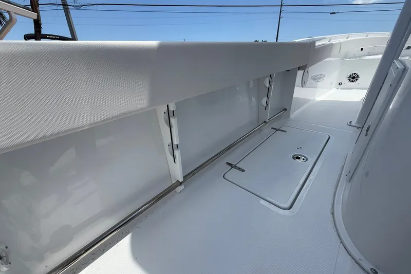 Slide: The Image of 2026 Sea Hunt Gamefish 25 boat interior, featuring sleek white deck and storage compartments. - 14