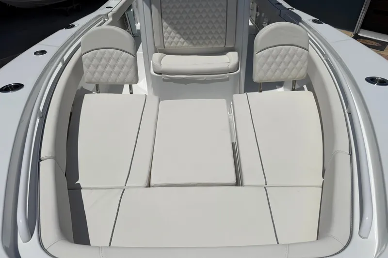 Slide: The Image of Luxurious seating area on a 2026 Sea Hunt Gamefish 25 boat, featuring plush white cushions. - 32