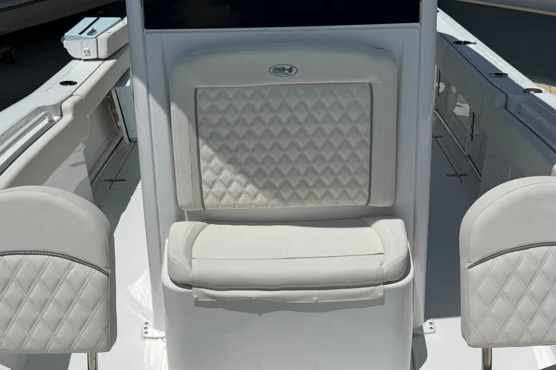 Slide: The Image of 2026 Sea Hunt Gamefish 25 boat interior with cushioned seating and sleek design. - 33