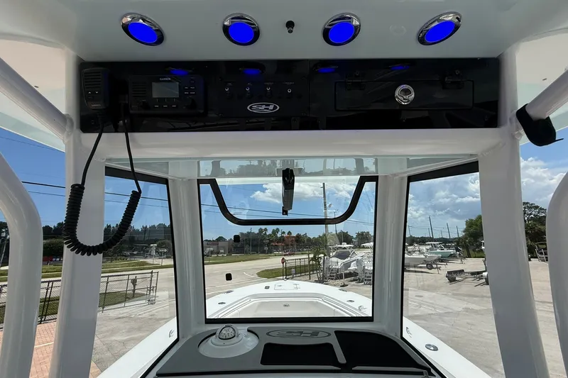 Slide: The Image of Interior view of 2026 Sea Hunt Gamefish 25 boat with control panel and blue lights. - 17