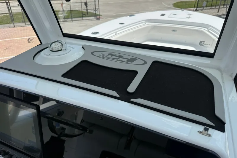 Slide: The Image of 2026 Sea Hunt Gamefish 25 dashboard with compass and storage area. - 21