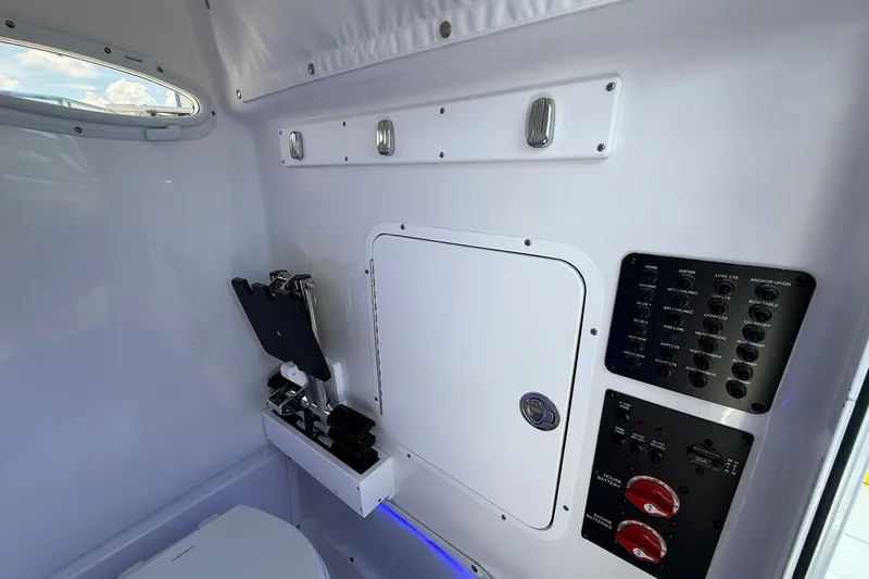 Slide: The Image of Interior of 2026 Sea Hunt Gamefish 25 boat with control panel and storage compartment. - 37