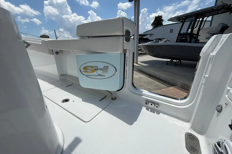 Slide: The Image of 2026 Sea Hunt Gamefish 25 boat interior with open door and logo. - 13