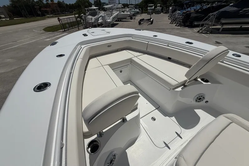 Slide: The Image of 2026 Sea Hunt Gamefish 25 boat interior with white seating and cup holders. - 27